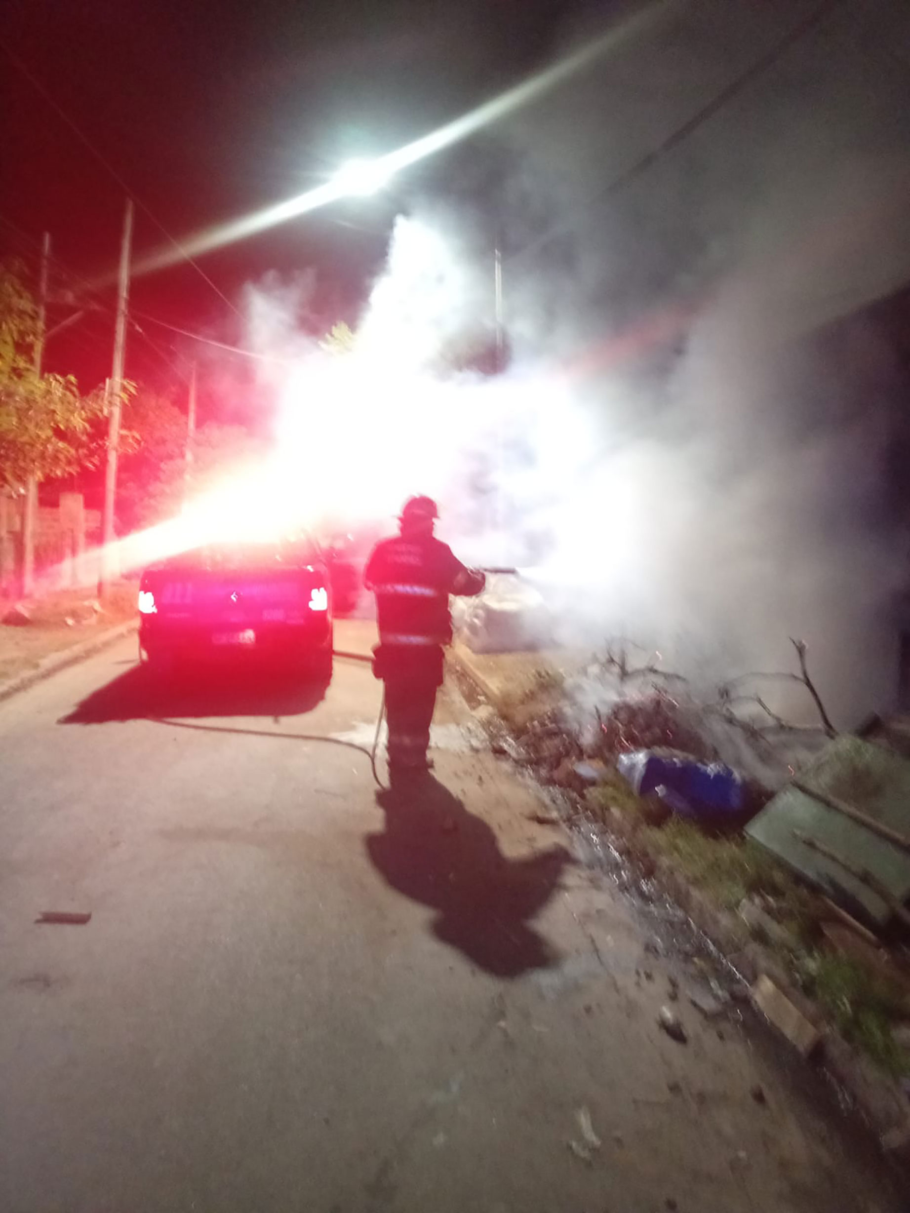 Incendio de basura en la vereda de una vivienda